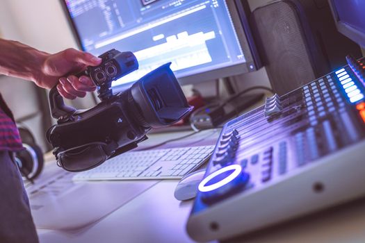 Video editing, recording and cutting room with monitors, camera and sound mixing desk