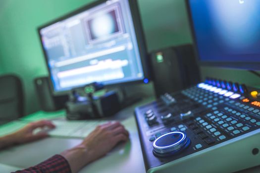 Video editing, recording and cutting room with monitors and sound mixing desk