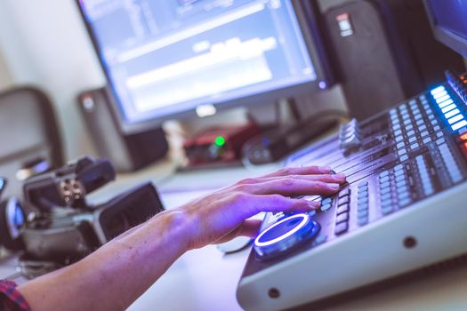 Video editing, recording and cutting room with monitors and sound mixing desk