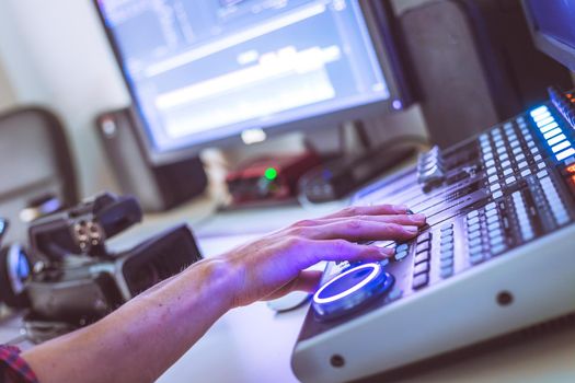 Video editing, recording and cutting room with monitors and sound mixing desk