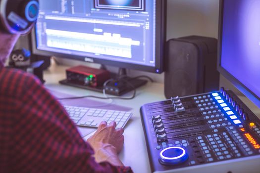 Video editing, recording and cutting room with monitors and sound mixing desk