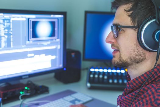 Video editing, recording and cutting room with monitors and sound mixing desk