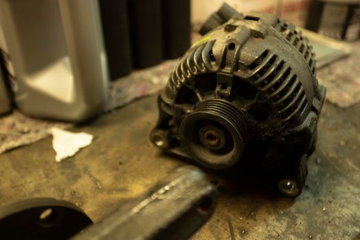 Old worn alternator of the car to be replaced