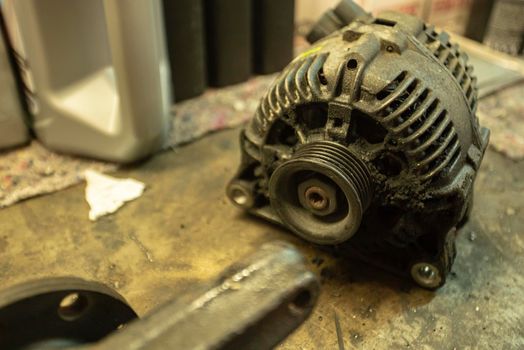 Old worn alternator of the car to be replaced