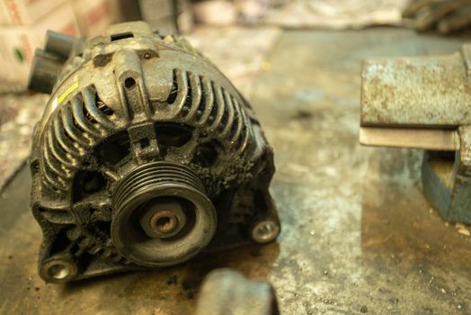 Old worn alternator of the car to be replaced