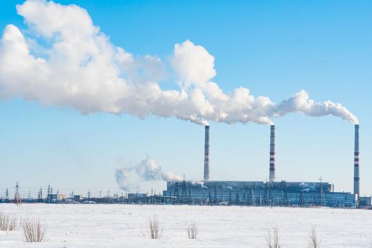 Smoking factory chimneys.Environmental problem of pollution of environment and air in large cities.Climate change,ecology and global warming.The sky is smoky with toxic substances.Soot from factories