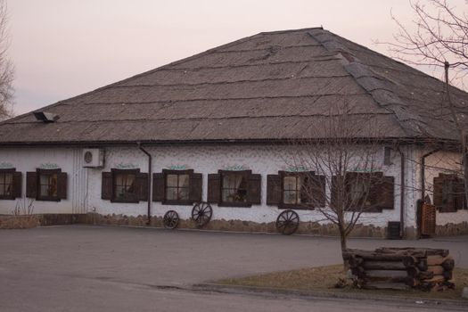 A large one-story house with a thatched roof in the Ukrainian style.