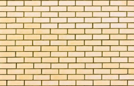 Photograph of a brick wall pattern. The bricks are light yellow in colour.