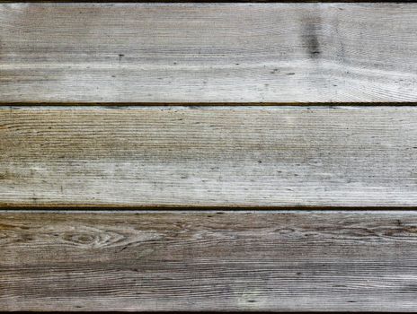 Three horizontal natural wooden panels. The panels are light in colour and have a silver tint.