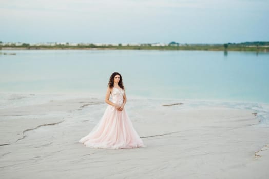 girl in a pink dress are walking along the white sand of the desert