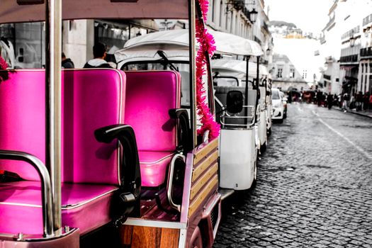 Colorful Tuk Tuks parked in a Lisbon street in Spring