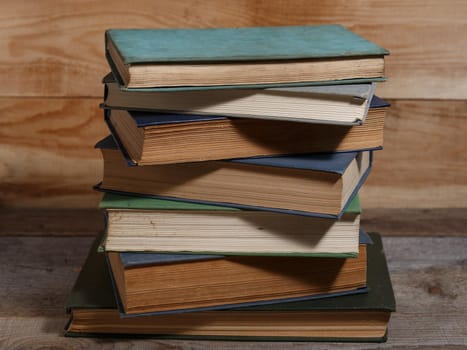 Old shabby books on brown backgrounds from wooden boards.