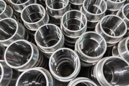 shiny bare steel parts after cnc turning operations close background with selective focus, view from top