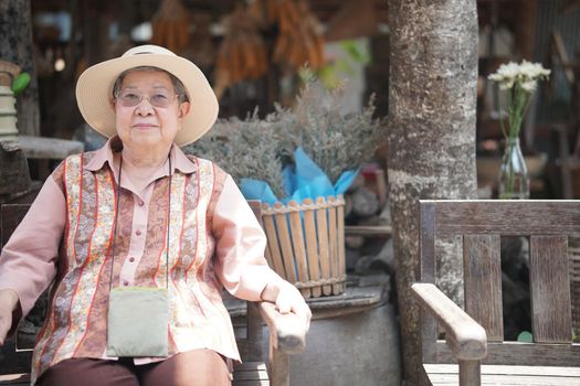 asian old elder woman elderly female relaxing resting on terrace at home. senior leisure lifestyle