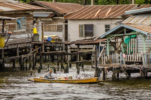 Bangkok, Thailand - Jun 30, 2019 : Uncle selling fruits on old boat on the river, Foods for villager riverside.