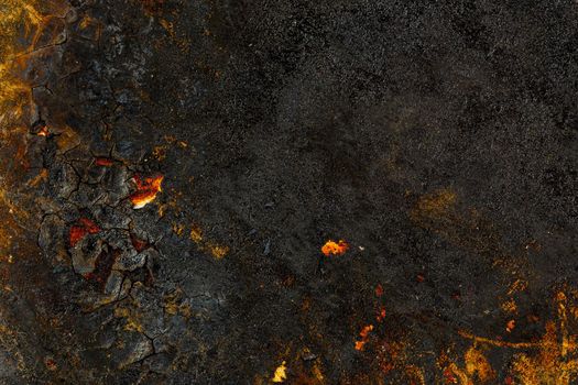 Bottom side of a cast iron pan with thicl layer of soot on its surface. Texture and background.
