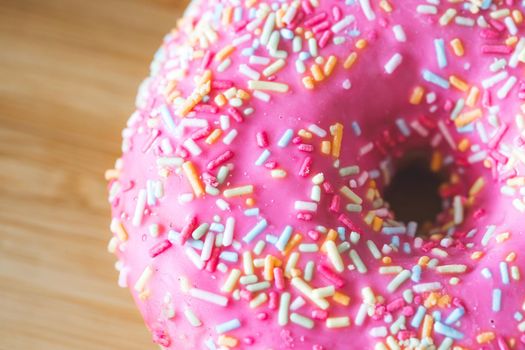 Close up of sugar sprinkled pink donut glace