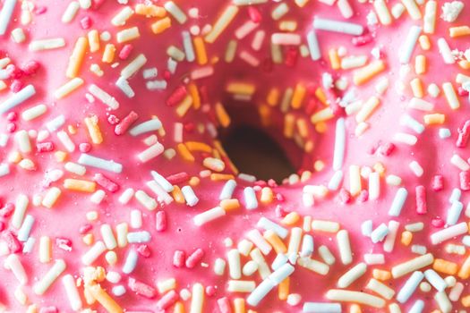 Close up of sugar sprinkled pink donut glace