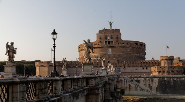 Wide-shot of Ponte Sant'Angelo with Castel Sant'Angelo in the background on a sunny day