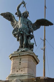 Close-up of Saint Michael sculpture at the top of Sant'Angelo Castle at Rome against a clear blue sky