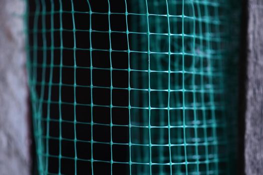 geometrically distorted texture grid. green grid background. Selective focus. High quality photo