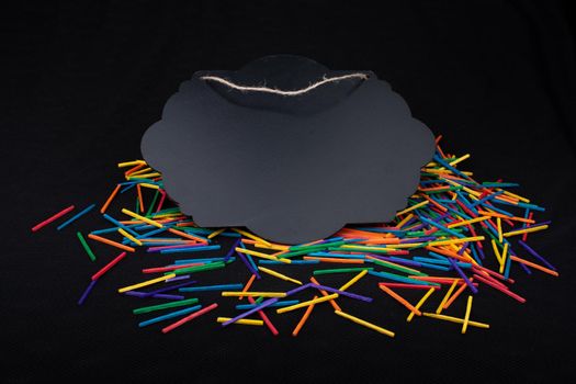 Black speech bubble shaped notice board  on colorful sticks on black