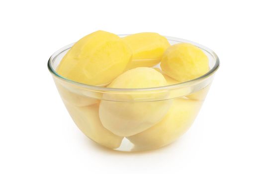 Peeled potatoes in a glass bowl isolated on white background. With clippig path