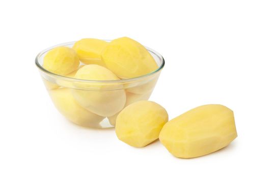 Peeled potatoes in a glass bowl isolated on white background. With clippig path