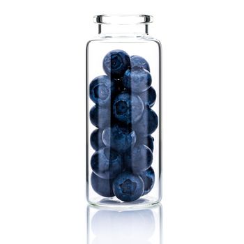 Homemade skin care with  blueberry in a glass bottle isolated on white background.
