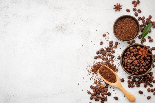 Background of various coffee , dark roasted coffee beans , ground and capsules with scoops setup on white concrete background with copy space.