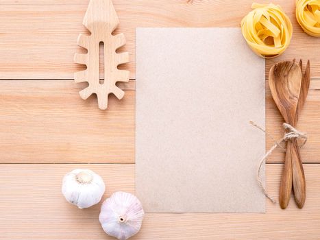 Italian foods concept and menu design . Blank paper and  pasta ladle on wooden background.