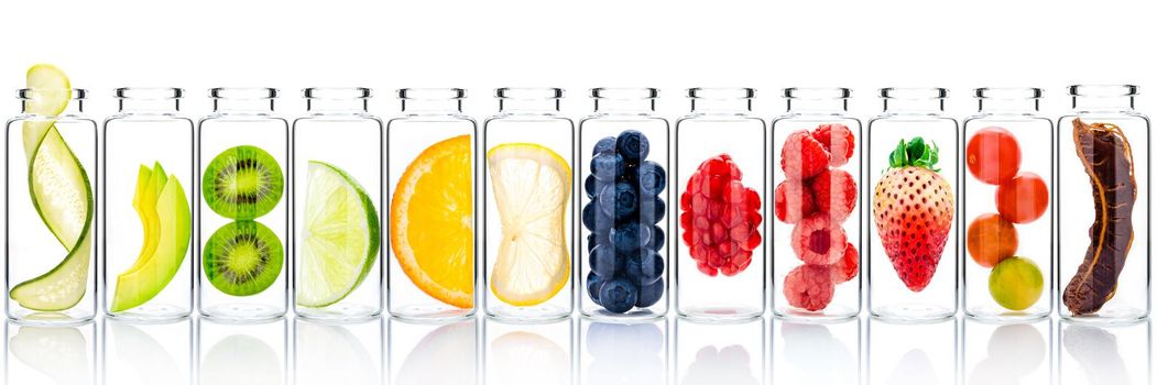 Homemade skin care with fruits ingredients avocado ,orange ,blueberry ,pomegranate ,kiwi ,lemon slice ,cucumber ,tamarind ,strawberry and raspberry in glass bottles isolated on white background.