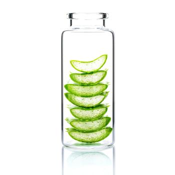Homemade skin care with aloe vera slice in a glass bottle isolated on white background.
