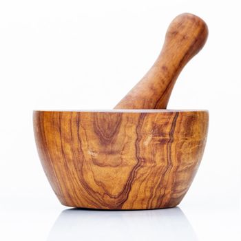 Closeup handmade wooden mortar and pestle isolated on white background . 