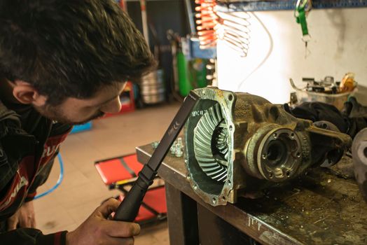 MILAN, ITALY 28 MARCH 2021: Mechanic repairs the gearbox