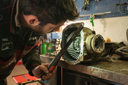 MILAN, ITALY 28 MARCH 2021: Mechanic repairs the gearbox