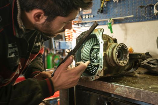 MILAN, ITALY 28 MARCH 2021: Mechanic repairs the gearbox