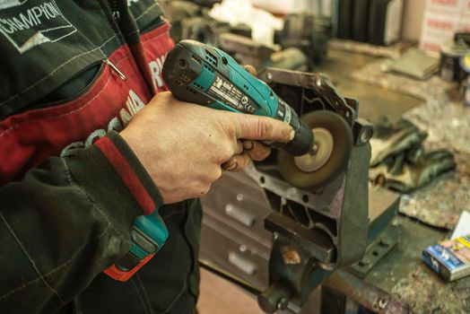 MILAN, ITALY 28 MARCH 2021: Mechanic cleans the spare part