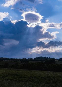 Beautiful cloudy sky with sun shining behind them