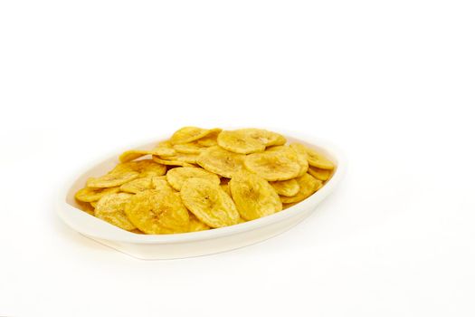 Banana chips in a serving bowl on a white background