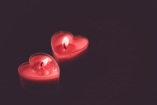 Couple heart is candles on dark background