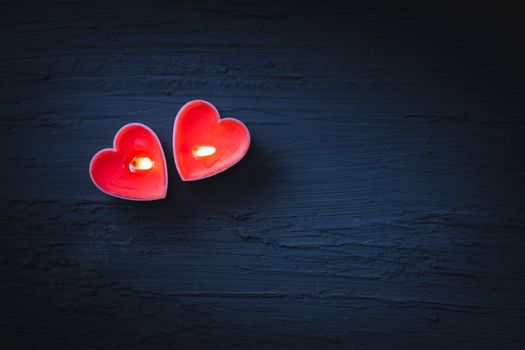 Couple heart is candles on dark background
