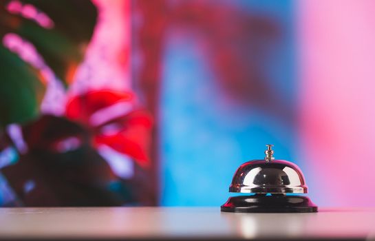 Bell of service on counter with colorful background