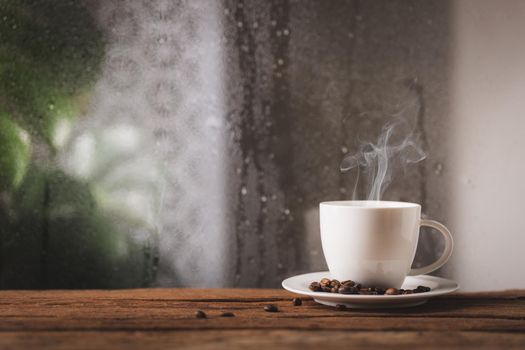 Coffee cup on a rainy day window background