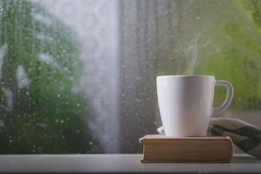 Coffee cup on a rainy day window background