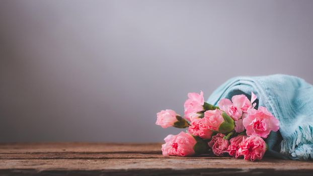 Still life with sweet carnation flowers on wooden table, Mothers day concept