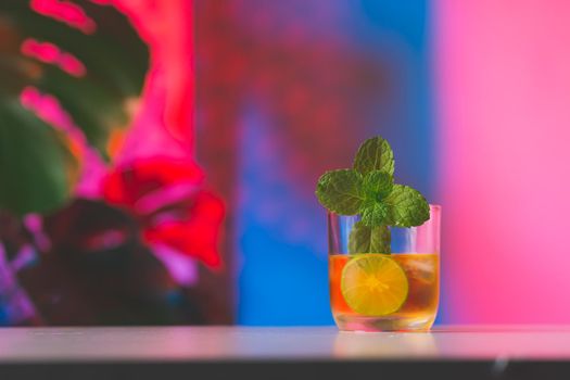 Cocktail on colorful lighting background
