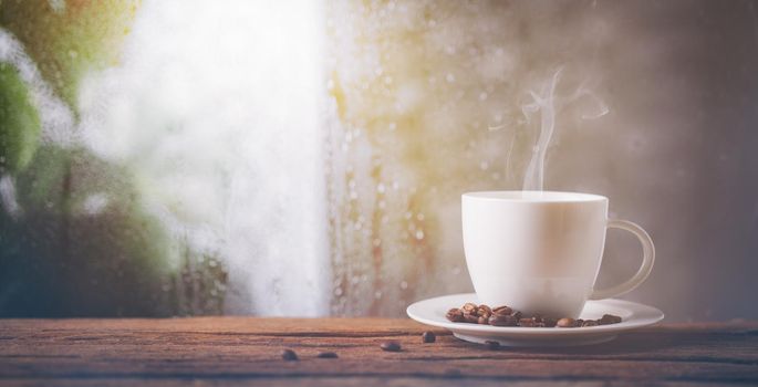 Coffee cup on a rainy day window background