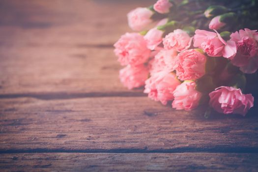 Still life with sweet carnation flowers on wooden table, Mothers day concept