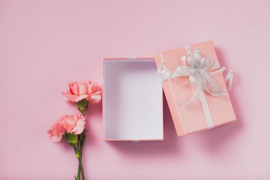 Gift box open with carnation flowers, Mother's Day and Valentines Day concept